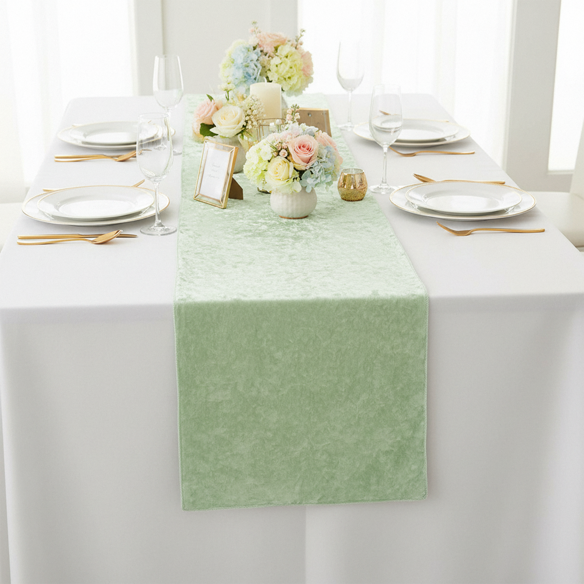 Velvet Table Runner Mint Green on a white tablecloth, white dinner plates and mixed floral centerpiece