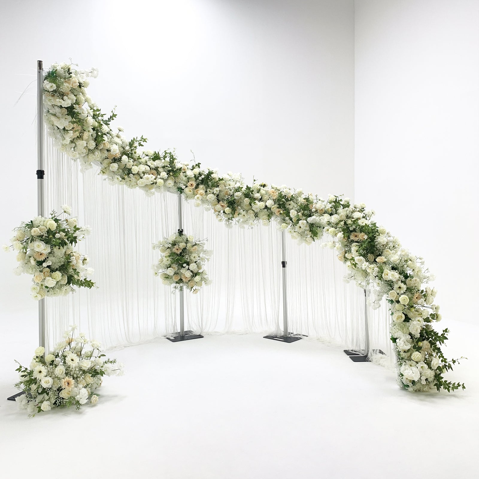 Modern s-curved metal wedding arch backdrop frame decorated with florals and drapes