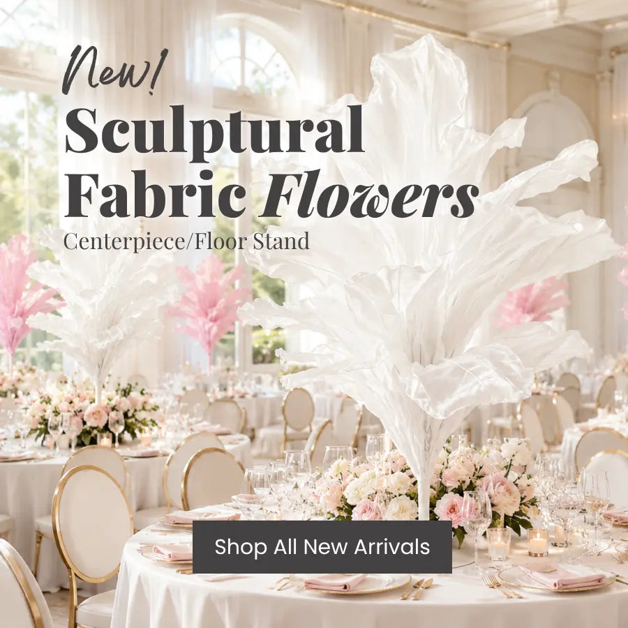 White sculptural fabric flowers centerpiece on a tall floor stand, wedding reception decor.