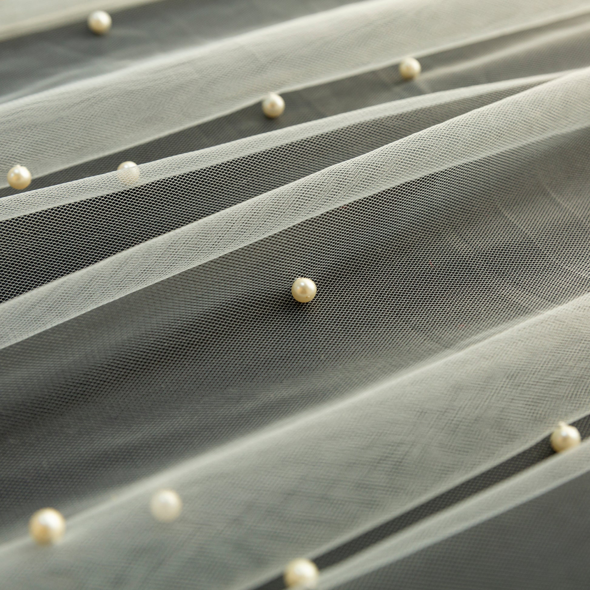 Pearl Tulle Table Runner 30" x 120" Ivory close up on top a black tablecloth