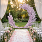 Pink Cherry Blossom Crescent Arch Backdrop wedding altar with white aisle runner and rose petals