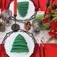 Premium Polyester Napkin 19"x19" - Emerald Green christmas tree fold with white charger on a black placemat, chrismtas table setting