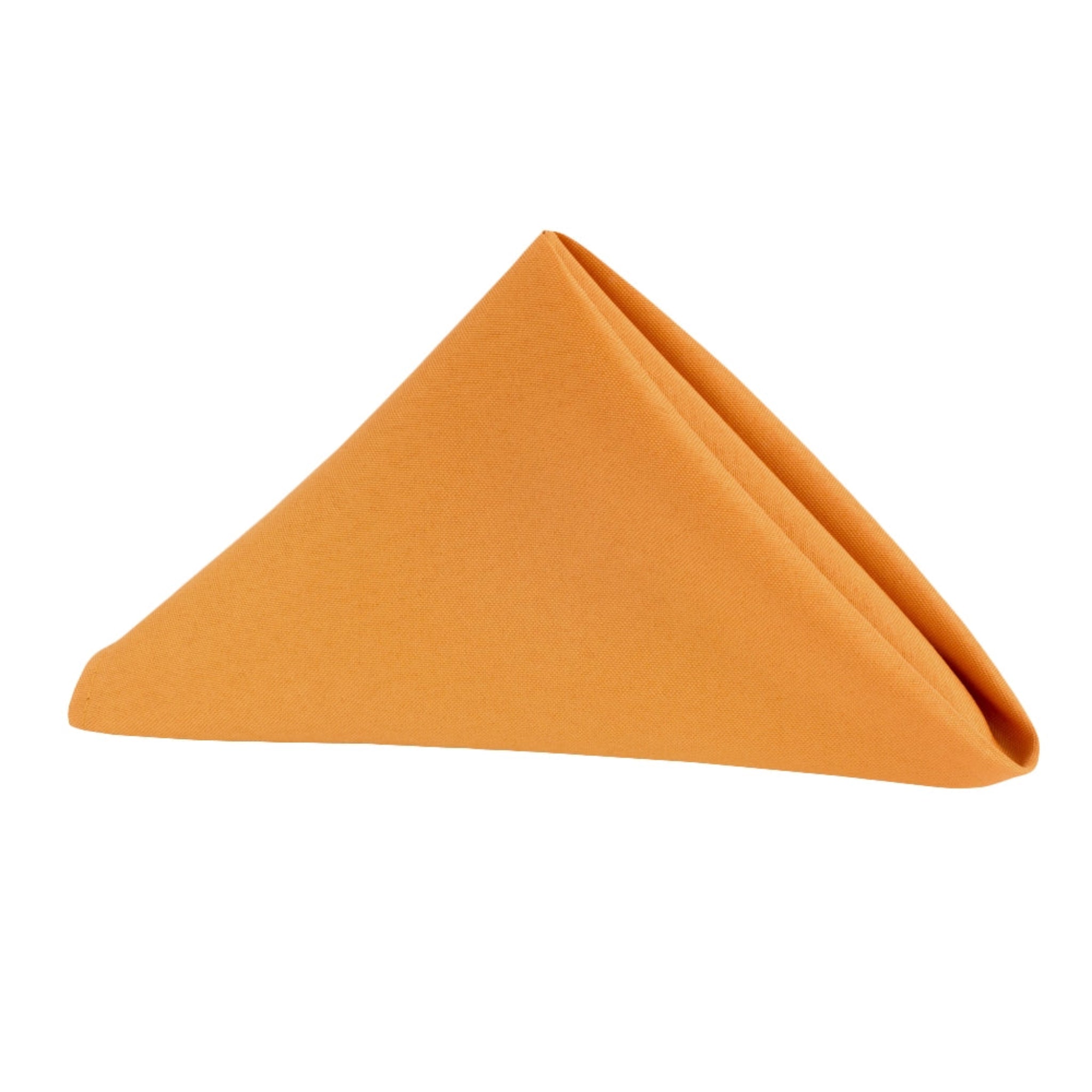 Burnt orange polyester napkin folded into a neat triangle for formal place setting.