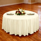 Premium 132" Round Ivory Spun Polyester Tablecloth table setting with floral centerpiece, gold charger plates and ivory napkins