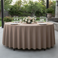 Premium Polyester 90" Round Tablecloth Taupe paired with wine goblets, floral centerpiece, white charger plates and gold silverware