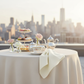 front detail of Premium Polyester Napkin 20"x20" - Light Ivory/Off White used on a rooftop afternoon tea party