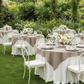 Premium Polyester Square 54" Overlay/Tablecloth Taupe with wine goblets, floral centerpiece, and gold charger plates