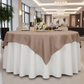Premium Polyester Square 72" Overlay/Tablecloth Taupe on a 60" round table paired with wine goblets, tapered candles, floral centerpiece, charger plates
