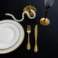 Premium Satin (Wrinkle-Resistant) King 108"x156" Rectangular Tablecloth Black table setting with white charger plates, gold silverware and wine glass