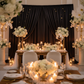 Premium Satin (Wrinkle-Resistant) Backdrop Panel/Drape Black behind a wedding sweetheart table with LED lstring lights and florals