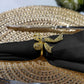 Premium Spun Polyester Napkin 20"x20" Black with a gold bow napkin ring on a gold charger plate