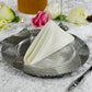 Premium Spun Polyester Napkin 20"x20" Ivory triangle fold ontop a silver charger plate