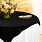 table setting with floral centerpiece, gold charger plate, ivory napkin ontop a white tablecloth 