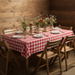 Rectangular Tablecloth 60"x84" Waterproof Vinyl Flannel Backing Checkered Design - Red on a table setup for rustic themed indoor dinner