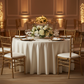 Round 108" Lamour Satin Tablecloth - Ivory with gold charger plate | ivory napkin | wine goblets | gold chiavari chair