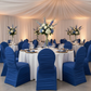 Ruched Fashion Spandex Banquet Chair Cover - Royal Blue for charity auction with gold charger plate | white dinner plate | royal blue napkin | white tablecloth