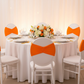 Ruffled Spandex Chair Band - Orange on top of white chair for birthday reception with white charger plate and dinner plate