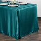Satin Rectangular Tablecloth 90"x132" Peacock table setting with white chargers, and clear wine goblets