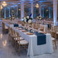 Satin Table Runner - Navy Blue on top of white tablecloth with gold charger plates and chiavari chairs