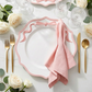 Scalloped Bow Acrylic Charger Plate Pink with a pink napkin and roses
