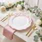 Scalloped Bow Acrylic Charger Plate Pink with a pink napkin, silver dollar eucalyptus greenery runner, white roses and gold utensils