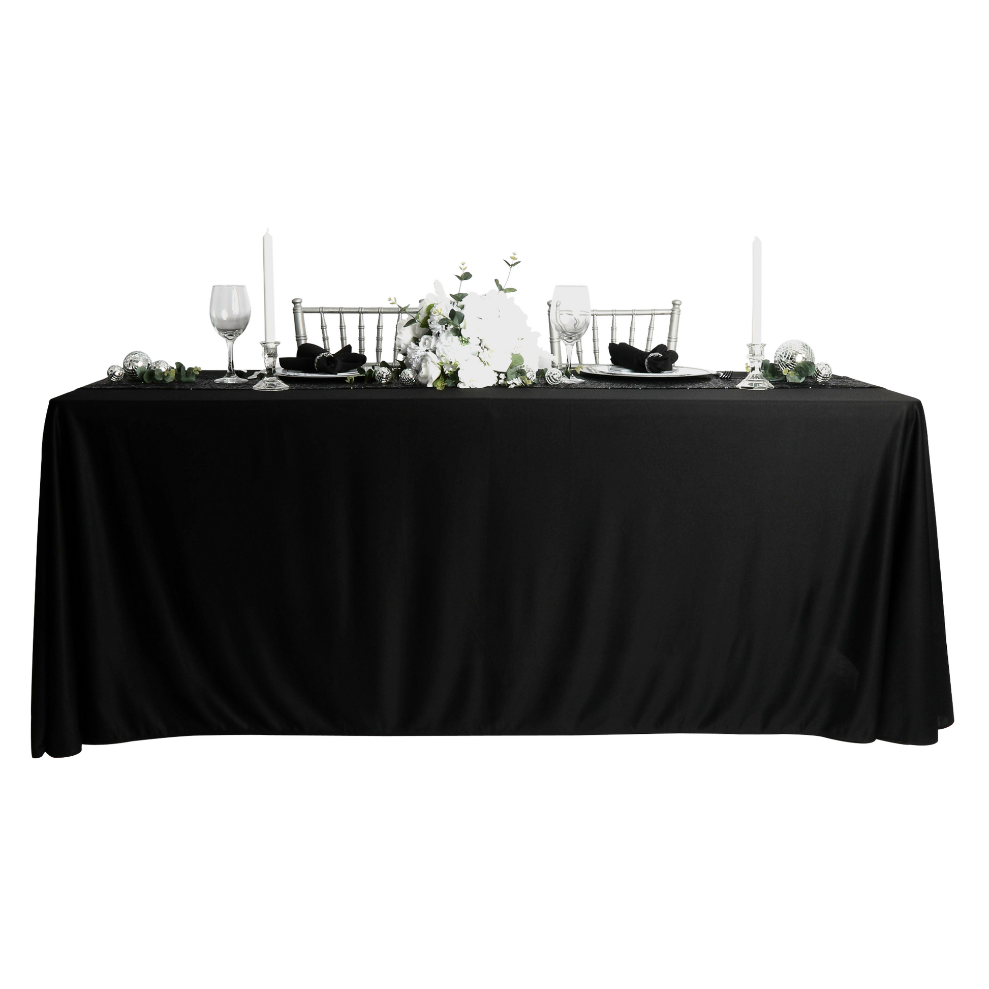 Scuba King 108"x156" Rectangular Tablecloth Black paired with white florals, black polyester napkins, wine goblets, and tapered candles