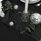 Scuba King 108"x156" Rectangular Tablecloth Black paired with disco balls, glitz black table runner, faux greenery and tapered candles