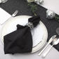 Scuba King 108"x156" Rectangular Tablecloth White paired with silver charger plate, white dinner plates, black polyester napking with crystal napkin 