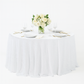 Sequin velvet 132" round tablecloth white with charger plates and florals