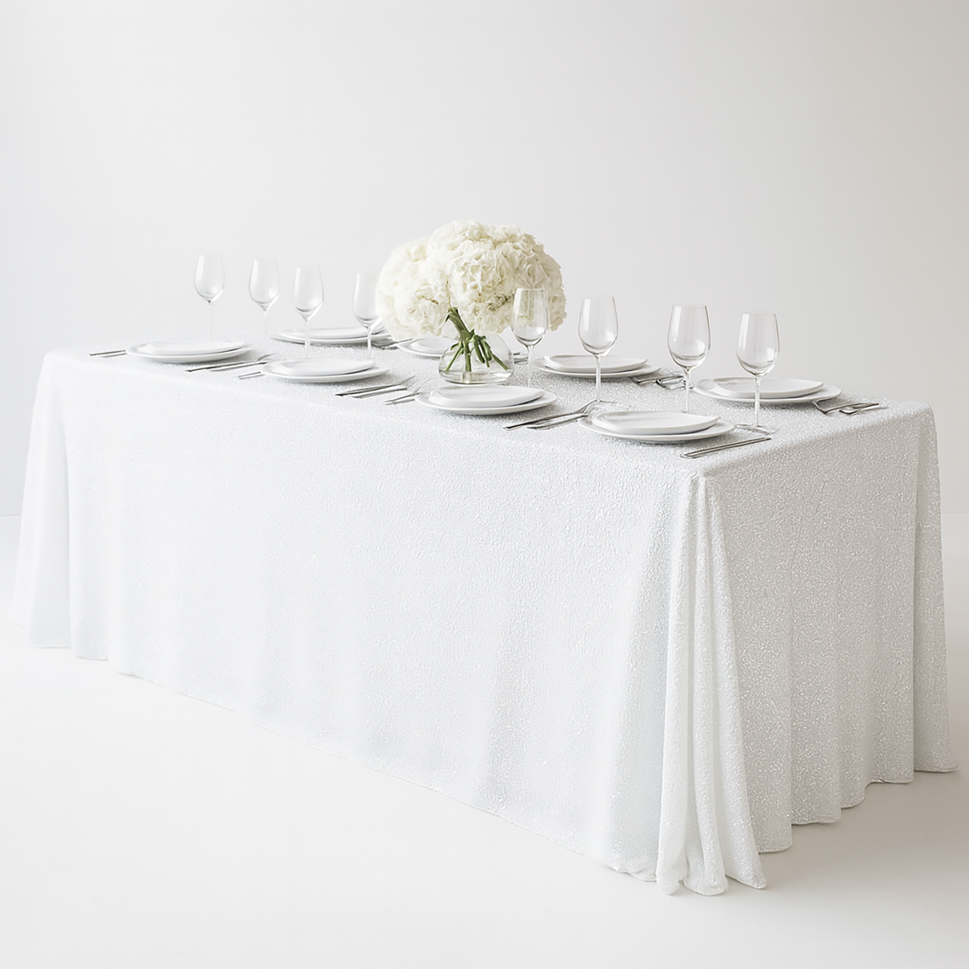 Sequin velvet rectangular tablecloth white with wine goblets and white charger plates