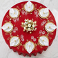 birds eye view of the Sequin Velvet Round Tablecloth Red with gold charger plates, water goblets and floral centerpiece