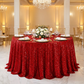 Sequin Velvet Round Tablecloth Red with gold charger plates, water goblets and white rose centerpiece