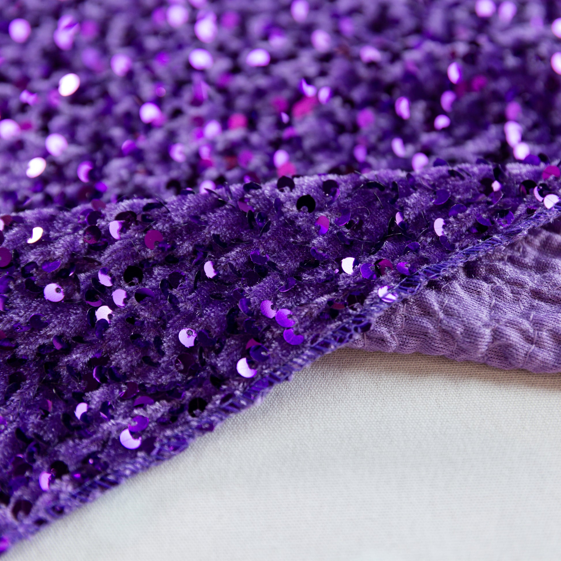 Sequin Velvet Table Runner Purple serged edge finish close up