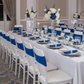 Spandex Chair Band - Royal Blue on top of chiavari chair | white tablecloth | silver charger plate | royal blue napkin