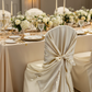 Universal Satin Self Tie Chair Cover - Champagne for birthday reception with gold charger plate | glass goblets | flower center pieces
