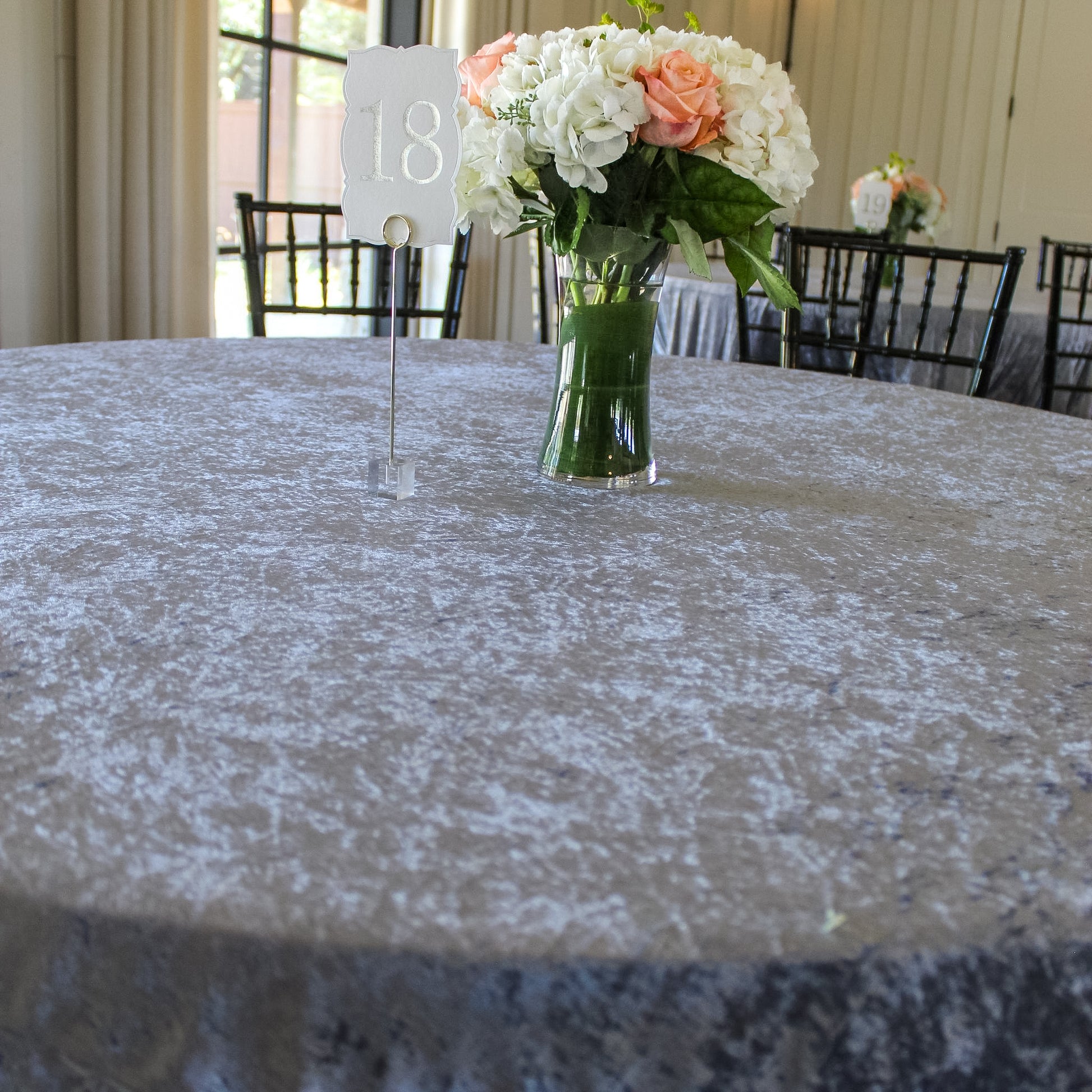 Velvet 108" Round Tablecloth Dusty Blue with clear vase with florals