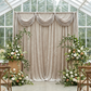 swag draping on a pipe set with two of the Velvet 10ft H x 52" W Drape/Backdrop Curtain Panel Taupe and floral centerpieces