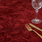 Velvet 120" Round Tablecloth Apple Red close up with flatware and wine goblet
