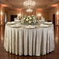 Velvet 132" Round Tablecloth Taupe on a 72 inch round table with a floral centerpiece ivory napkins, white dinner plates and tapered candles