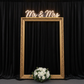 Velvet 18ft H x 52" W Drape/Backdrop Curtain Panel - Black on a photo booth setting with gold picture frame and mr&mrs neon sign on top