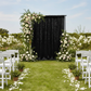 Velvet 18ft H x 52" W Drape/Backdrop Curtain Panel - Black with pink and ivory premade floral runners on a garden wedding reception