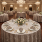 round table wedding table with the Velvet 20"x20" Linen Napkins Taupe  folded on top of the dinner plates, gold silverware and wine goblets