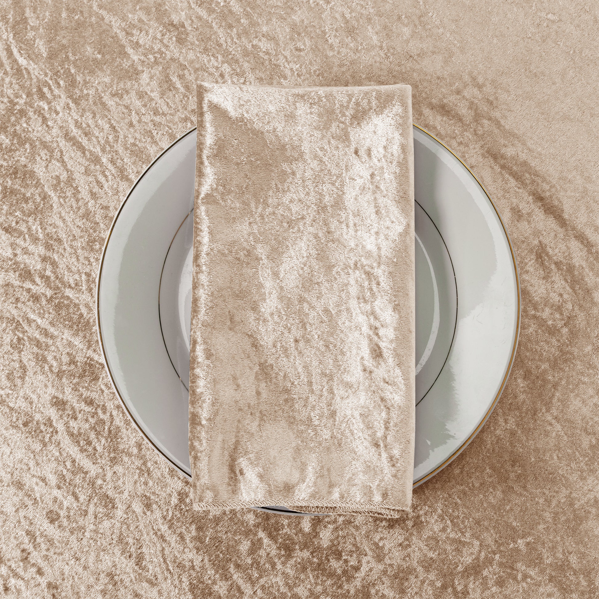Velvet 20"x20" Linen Napkin Taupe  on a white charger plate paired with a Velvet Taupe tablecloth