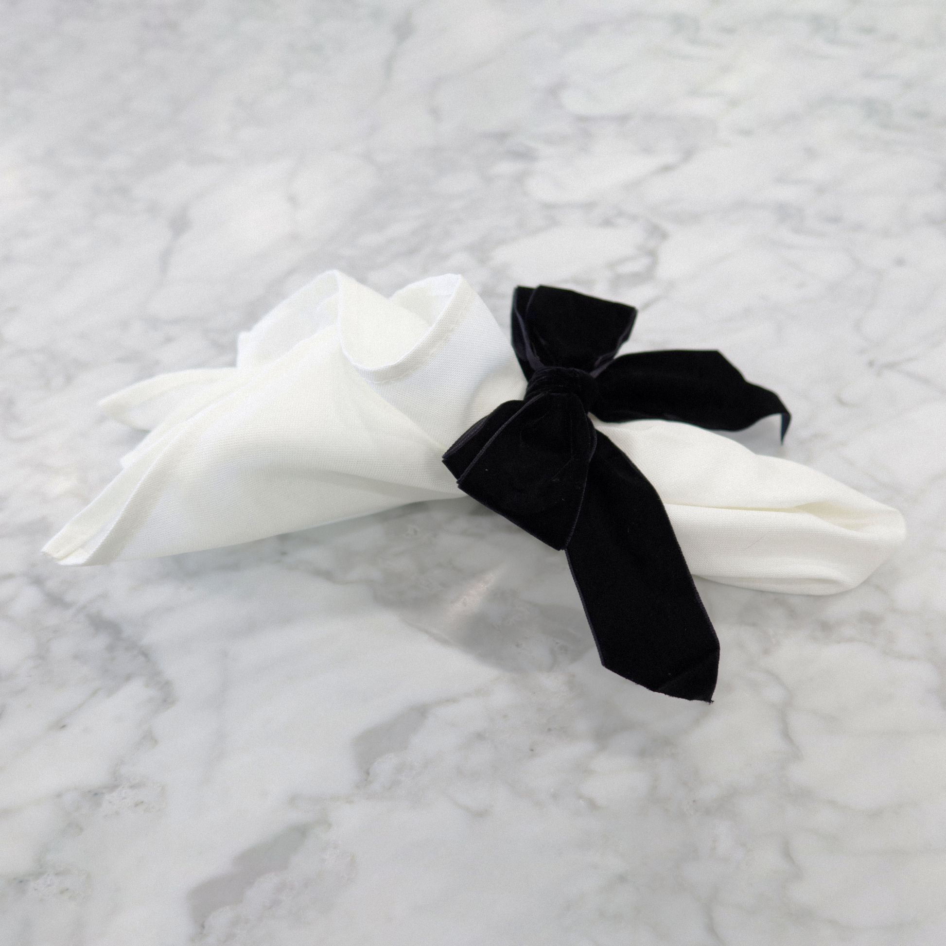 10 pc/pk Velvet Bow-Tie Napkin Ring Black on a white napkin