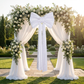 Velvet Giant Fabric Bow for Backdrop White outdoor on an arch with sheer white drapes and white roses and greenery