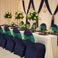 elegant indoor dinner with Velvet Ruffle Stretch Chair Band - Emerald Green on top of navy blue chair cover