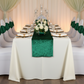 wedding reception with Velvet Ruffle Stretch Chair Band - Emerald Green and ivory tablecloth