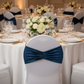 Velvet Ruffle Stretch Chair Band - Navy Blue on white spandex chair cover | with white tablecloth | white dinner plate | wine goblets | flower centerpiece