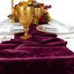 Velvet Table Runner Cabernet bunched in the middle of the table with gold goblets