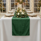 christmas dinner with the Velvet Table Runner Forest Green paired with white floral centerpieces, candles, and gold charger plates